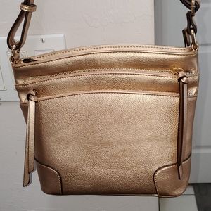 Gold metallic crossbody purse. Lots of zipper poc.